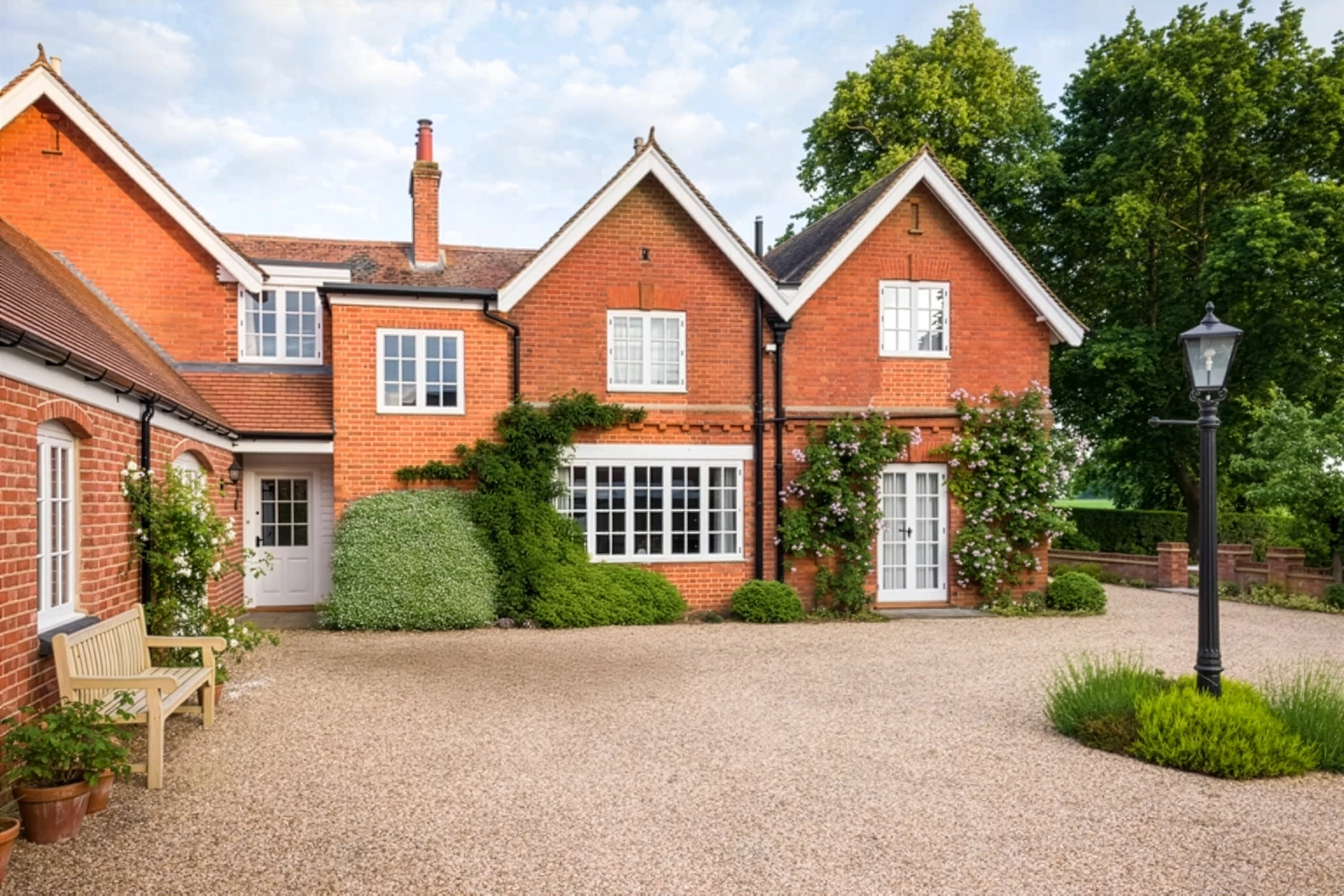 Terrasse résidentielle avec mobilier en rotin, balustrade ornementale en fer forgé et colonnes en pierre naturelle
